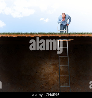 man look into ground hole Stock Photo