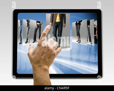 Holding and pointing to blank screen on digital tablet with copy space isolated on white Stock Photo