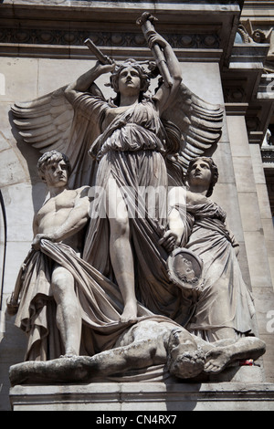 A statue of an angel standing on a corpse with two other people by her side, on a building in Paris, France Stock Photo