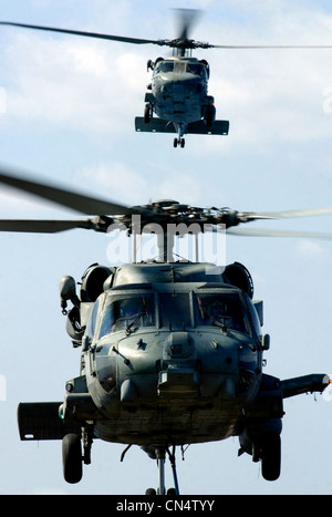 - In the skies above USS Ronald Reagan an HH-60H Seahawk and an SH-60F Seahawk both assigned to the ÒBlack KnightsÓ of Helicopter Anti-Submarine Squadron (HS) 4 move into position to transfer ordnance between the Nimitz-class nuclear powered aircraft carr Stock Photo