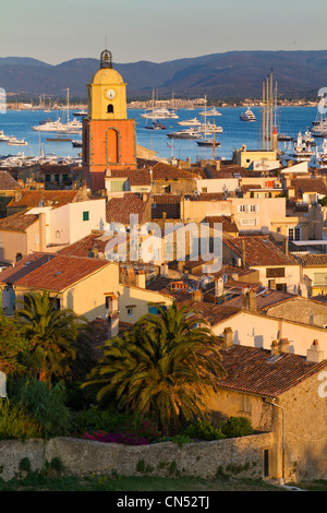 France, Var, Saint Tropez, the clock of the bell tower of the parish church built in 1634 with ochre color, seen from the