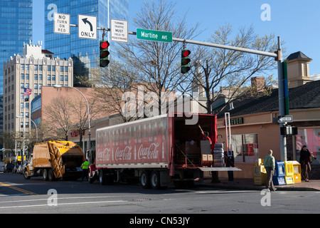 A rear-loading truck makes a curbside Coca-cola delivery at a 7-Eleven store in White Plains, New York. Stock Photo