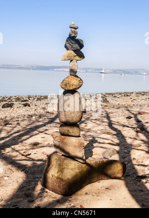 Stones balanced to form a towering stack, Queensferry beach, West Lothian, Scotland. Stock Photo