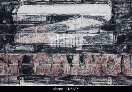 A stenciled number 2 and address in the process of being removed from a brick wall Stock Photo