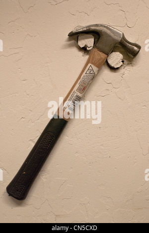 An artist's hammer hangs on cut-off prison bars in a converted jail cell at Michigan's oldest state prison in Jackson. Stock Photo