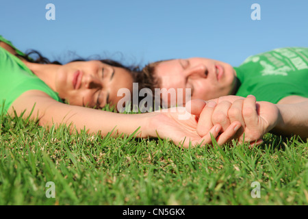 sleeping couple , focus on holding hands, Stock Photo