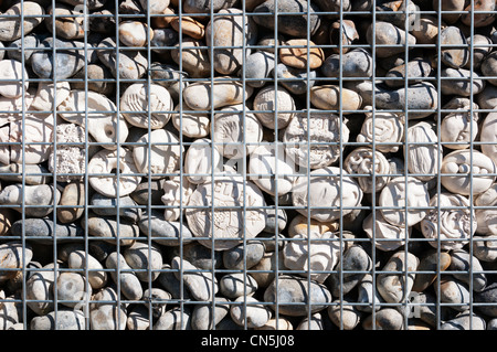 A line of ceramic pebbles forming a decorative feature in a wall of pebbles. Stock Photo