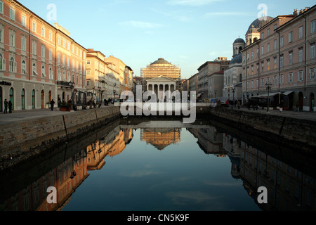 Buildings and boats reflected in the still water of the Grand Canal with the  Sant' Antonio Nuovo Church, Trieste, Italy Stock Photo