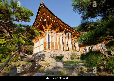 South Korea, South Gyeongsang Province, Jongbulam Buddhist Temple, facade, trees and blue sky Stock Photo