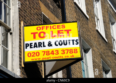 ‘ Offices to Let ‘ estate agent board on attached to the side of a building Stock Photo