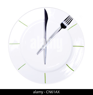 Clock made of knife and fork, isolated on white background Stock Photo