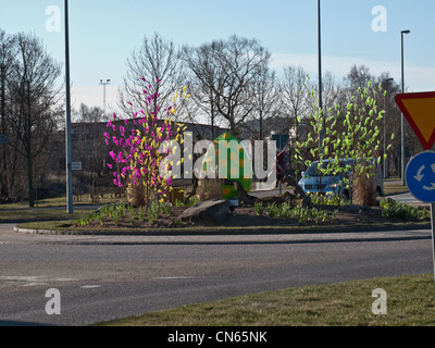 Roundabout with Easter feathers decorated trees. Stock Photo