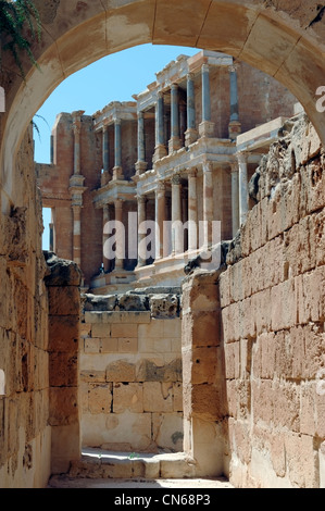 Partial view of the stage building through an arched auditorium lower entrance of the ancient Roman theatre at Sabratha Libya. Stock Photo