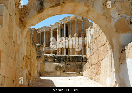 Sabratha. Libya. Partial view of the stage building through an arched auditorium lower entrance of ancient Roman theatre. Stock Photo