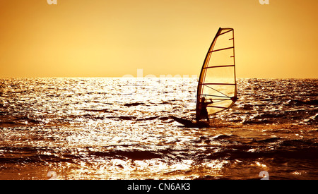 Windsurfer silhouette over sea sunset, panoramic beach landscape, summertime fun, sport, activities, vacation and travel concept Stock Photo