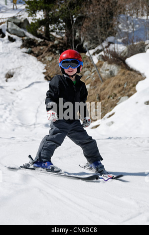 A young boy skiing on the piste by himself Stock Photo