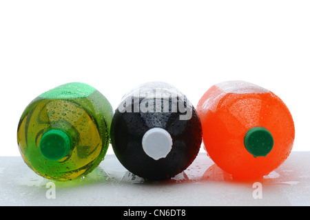 Three plastic two liter soda bottles laying on their sides with condensation on a wet counter. Stock Photo
