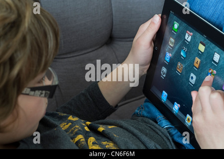 A young boy using  an iPad 2