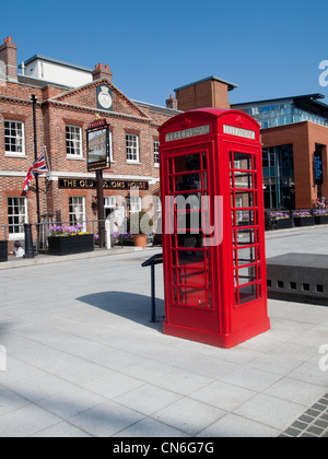 A red telephone box in front a public house in England Stock Photo