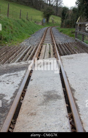 Narrow gauge railway track heading towards a bend in the distance Stock Photo