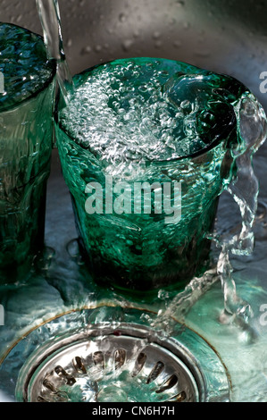 Two tumbler glasses overflowing with water Stock Photo