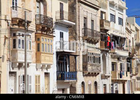 Collection of traditional Maltese town houses with balconies and bay windows, Kalkara, Malta, Europe Stock Photo