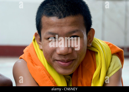 A Buddhist monk is posing for a portrait at a temple in Vientiane, Laos. Stock Photo