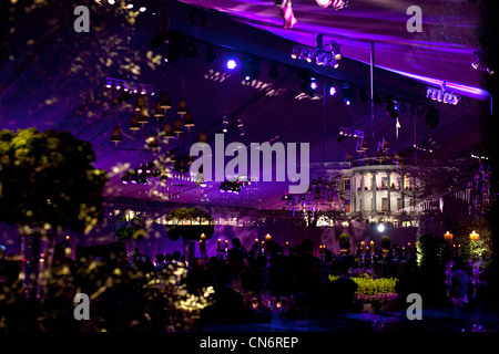 The White House is seen through the window of a tent on the South Lawn during the State Dinner in honor of British Prime Minister David Cameron and Samantha Cameron March 14, 2012 in Washington, DC. The interior of the tent is reflected in the window. Stock Photo