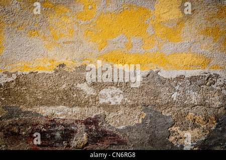 Grungy background. Old wall with some yellow color left on it. Lots of texture. Stock Photo