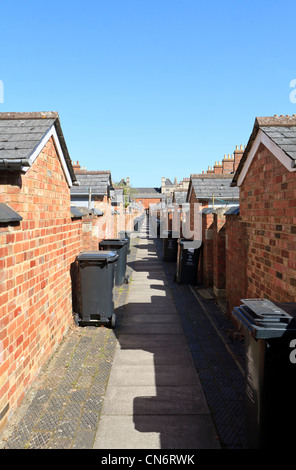 Wheelie bins in an alleyway between terraced housing in Saltaire ...