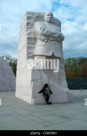 African American Woman standing beneath Sculpture of Martin Luther King at MLK Memorial in Washington DC Stock Photo