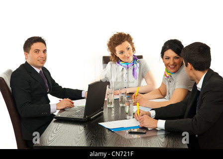 Business people having conversation at meeting in office and one business man smiling to camera Stock Photo