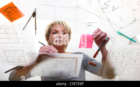 Architect working on a table in architectural drawings. Stock Photo