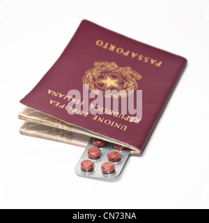 pills and a italian passport on a white background Stock Photo