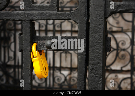Yellow padlock on a black metal gate, St Paul's Cathedral, London Stock Photo