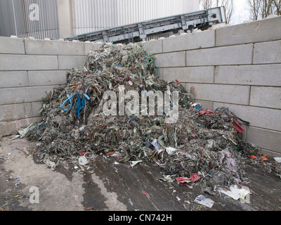 Pile of plastic waste that is a residue of used paper recycling, at a cardboard factory in Groningen Stock Photo