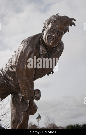 Close-up of bronze statue of cricketer Fred (Freddie) Trueman (front view of fast bower in action, bowling) - Skipton, North Yorkshire, England, UK. Stock Photo