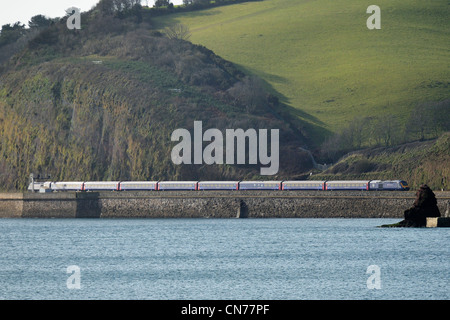 A First Great Western high speed train passes along the famous sea wall near Dawlish in Devon Stock Photo