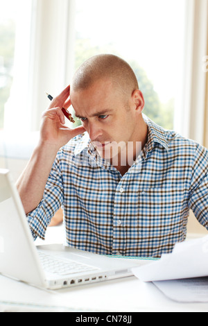 Male working out finances Stock Photo