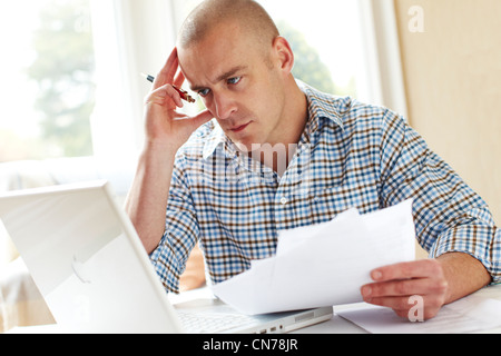 Male working out finances Stock Photo