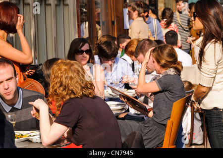 Eating  alfresco in Columbia Road, East London Stock Photo