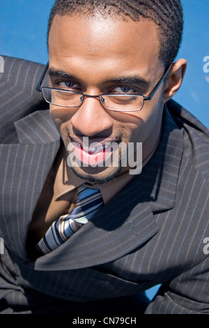 African American man in a business suit with eye glasses smiling happily. Stock Photo