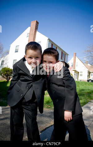 Two happy young boys dressed in suits with smiles on their faces. Stock Photo