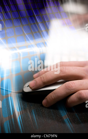 Montage of a hand using a computer mouse with high tech digital effects in the background. Stock Photo