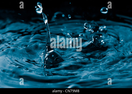 A water droplets background texture and splash. Shallow depth of field. Stock Photo