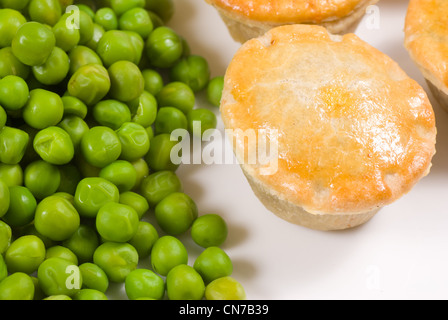 Pies served with peas, traditional English food Stock Photo