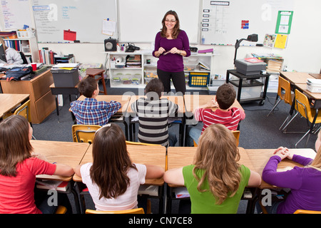 Female Teacher ethnically diverse students attention.multi ethnic multi racial diversity racially diverse multicultural multi cultural 12-13 year olds Stock Photo
