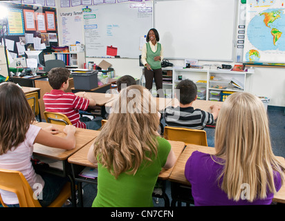 Boys girls school interracial female Teacher group multi ethnic multi idiversity racially diverse multicultural multi cultural 11-13 year old olds children Stock Photo