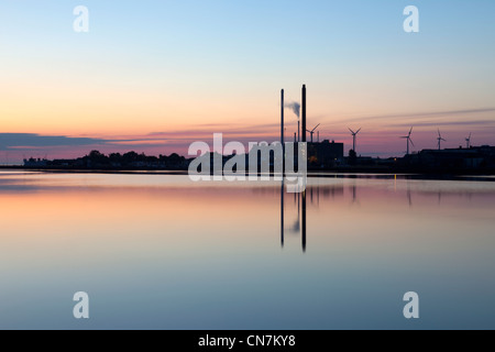 Smokestacks reflected in water Stock Photo