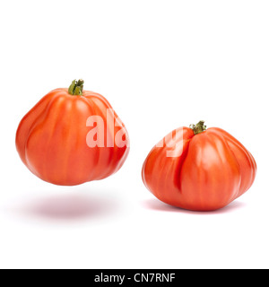 Two beefsteaks tomatoes up and down isolated on a white background Stock Photo